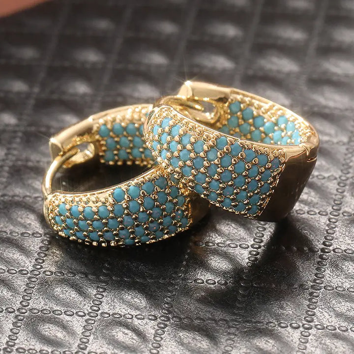 Eleganta hängande örhängen i guld med turkosa pärlor