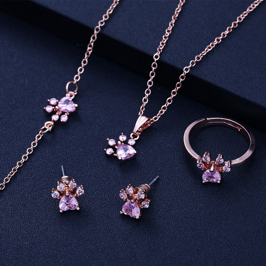 Roséguld Paws Smyckeset – 4 Delar med Zirkonia Hjärta" can be rewritten as:

"Roséguld Paws Smyckeset – 4 Delar med Zirkonia-Hjärta